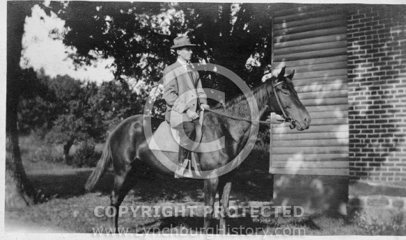 Man on Horse in Front of House