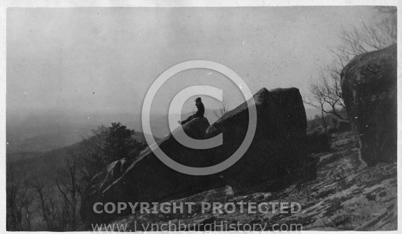 Man Sitting on Rock - Mountains in Background