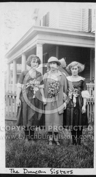 Duncan Sisters Standing in Front of House