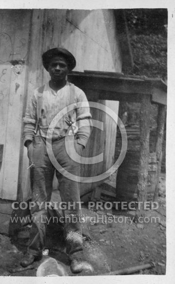 Black Man Standing in Front of Barn